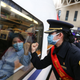 A train attendant gestures to medical staff in solidarity as the train leaves for Wuhan in Nanchang, China’s central Jiangxi province on February 13, 2020.